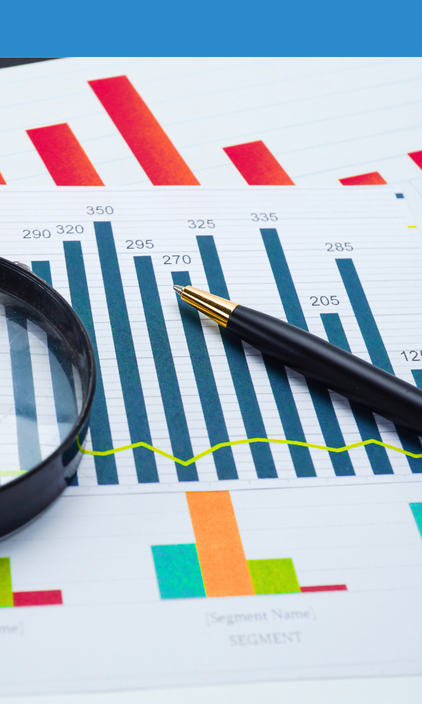 Printed charts and graphs with a pen and magnifying glass for data analysis